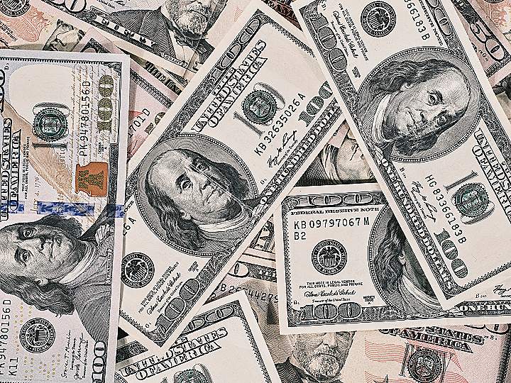 a pile of twenty dollar bills laying on top of each other